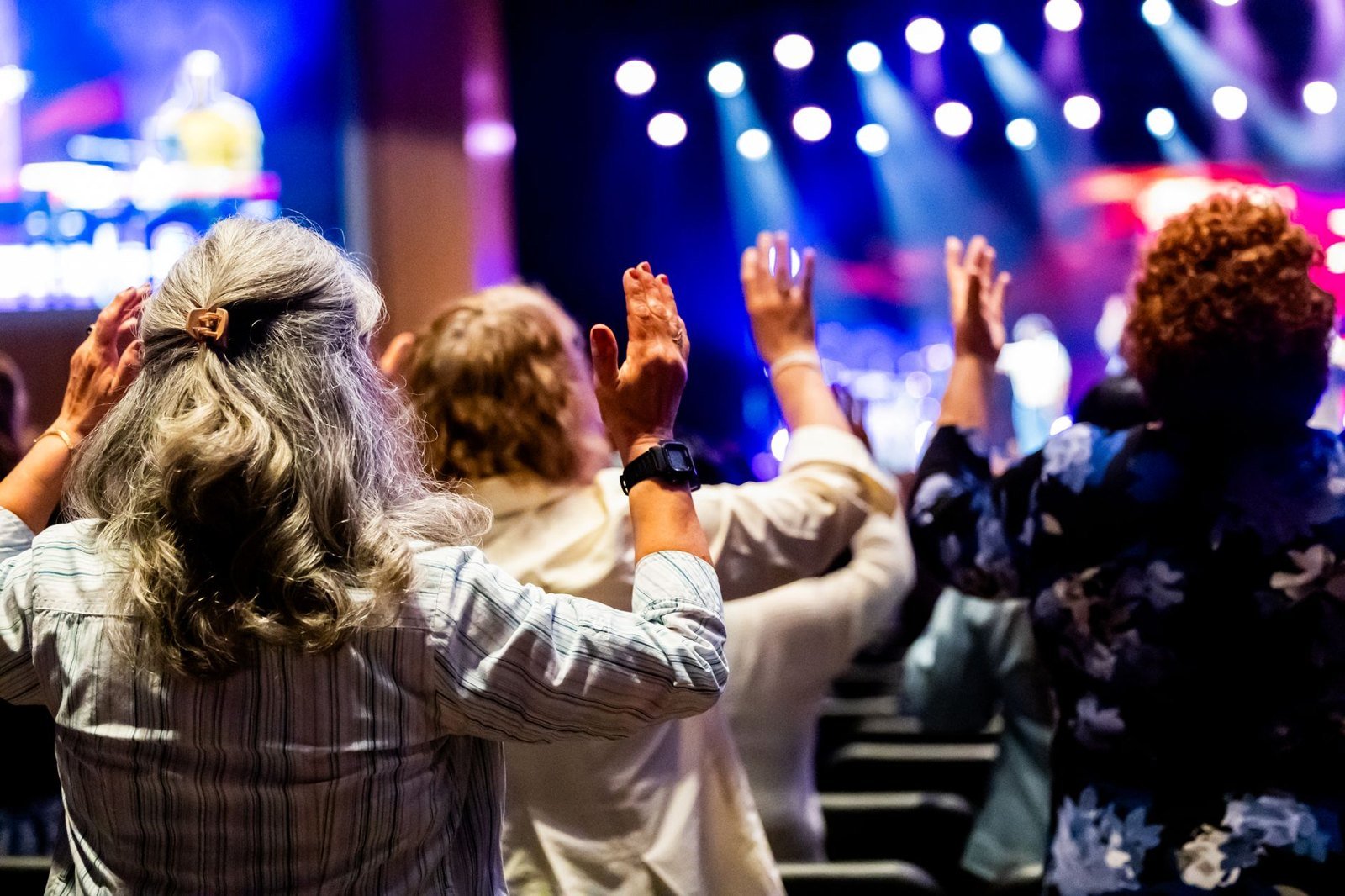 A congregation with raised hands during a worship service