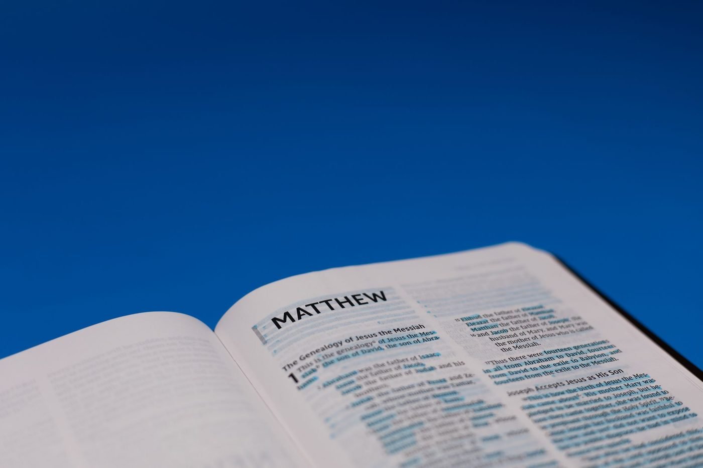 An open Bible showing the opening of the Gospel of Matthew
